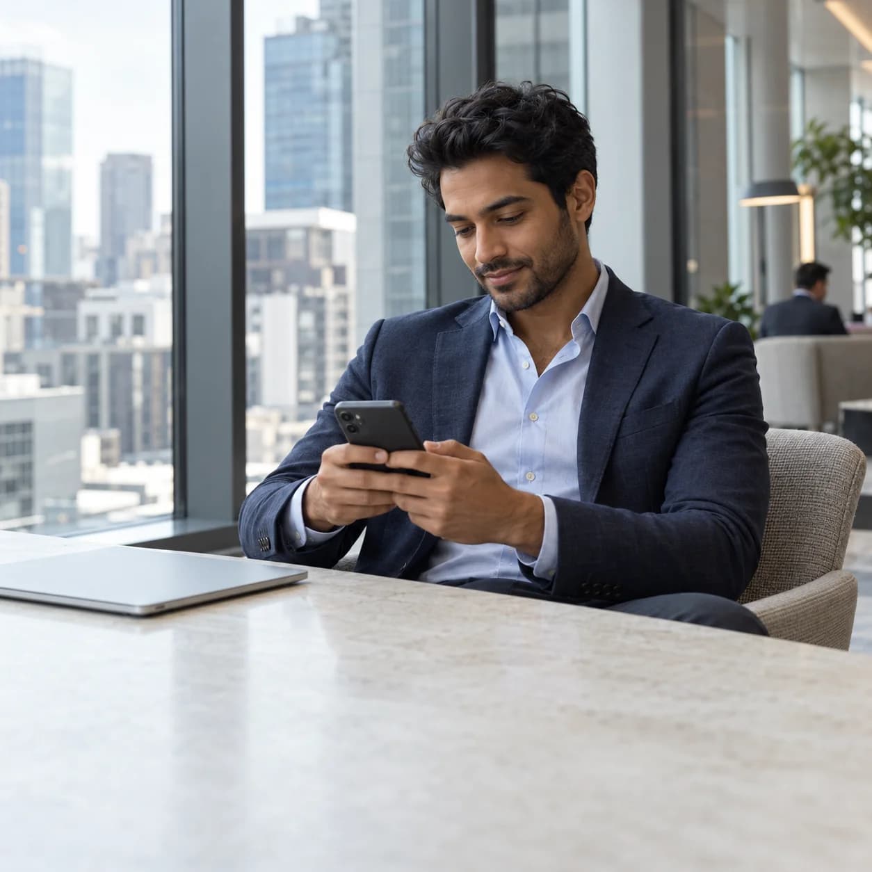 A professional checking his phone in a bright business lounge overlooking the city